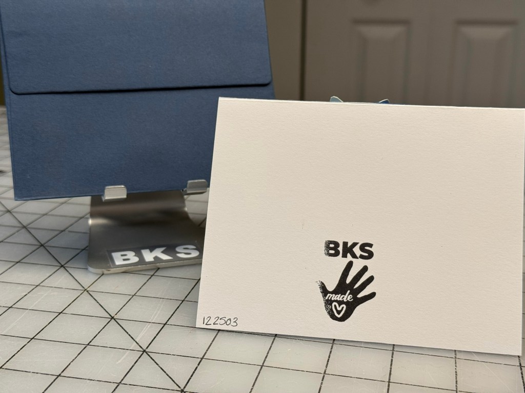 Handmade fantasy card featuring a fairy encased in an embossed flower bulb with butterflies and a glowing lantern